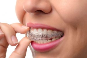 woman holding a Stittsville Invisalign